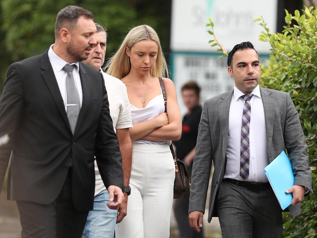 Kara Childerhouse (white dress) arrives at court with her partner’s lawyers, including Sam Saadat (left). Picture: John Grainger