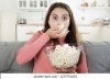 lady-eating-popcorn-while-looking-260nw-1275751654.jpg