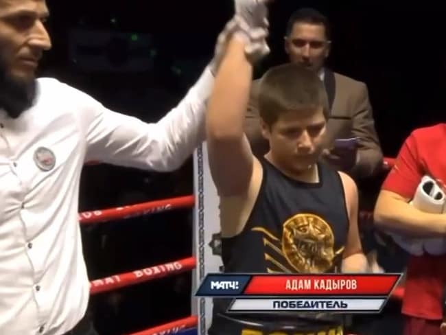 Adam Kadyrov has his hand raised as the winner.